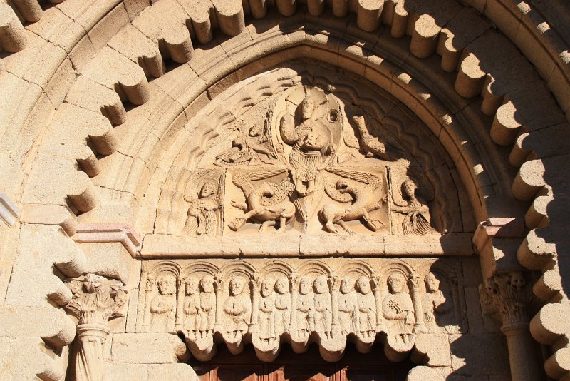 IMG_5511.JPG - Monolithe, il présente un bas-relief des apôtres, isolés ou groupés deux par deux. Seul St Pierre a pu être identifié grâce aux clefs qu'il tient en main.Cette particularité rappelle l'attachement de l'Ordre de Cluny à St Pierreet à ses successeurs, les Papes.Il est a noter que le décor de festons a été introduit en deux étapes.Lors de la création romane du portail , puis lors d'une réfection générale du XVIIe siècle.Aussi, lors du remontage, le thème des festons aurait été étendu et de ce fait, les pieds des apôtres des deux extrémités du linteau ont du être coupé.